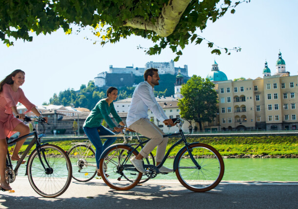     Cyclist on the banks of the river Salzach in Salzburg City 